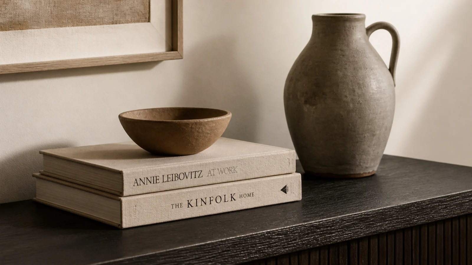 small bowl raised on two stacked hardback books on a foyer table