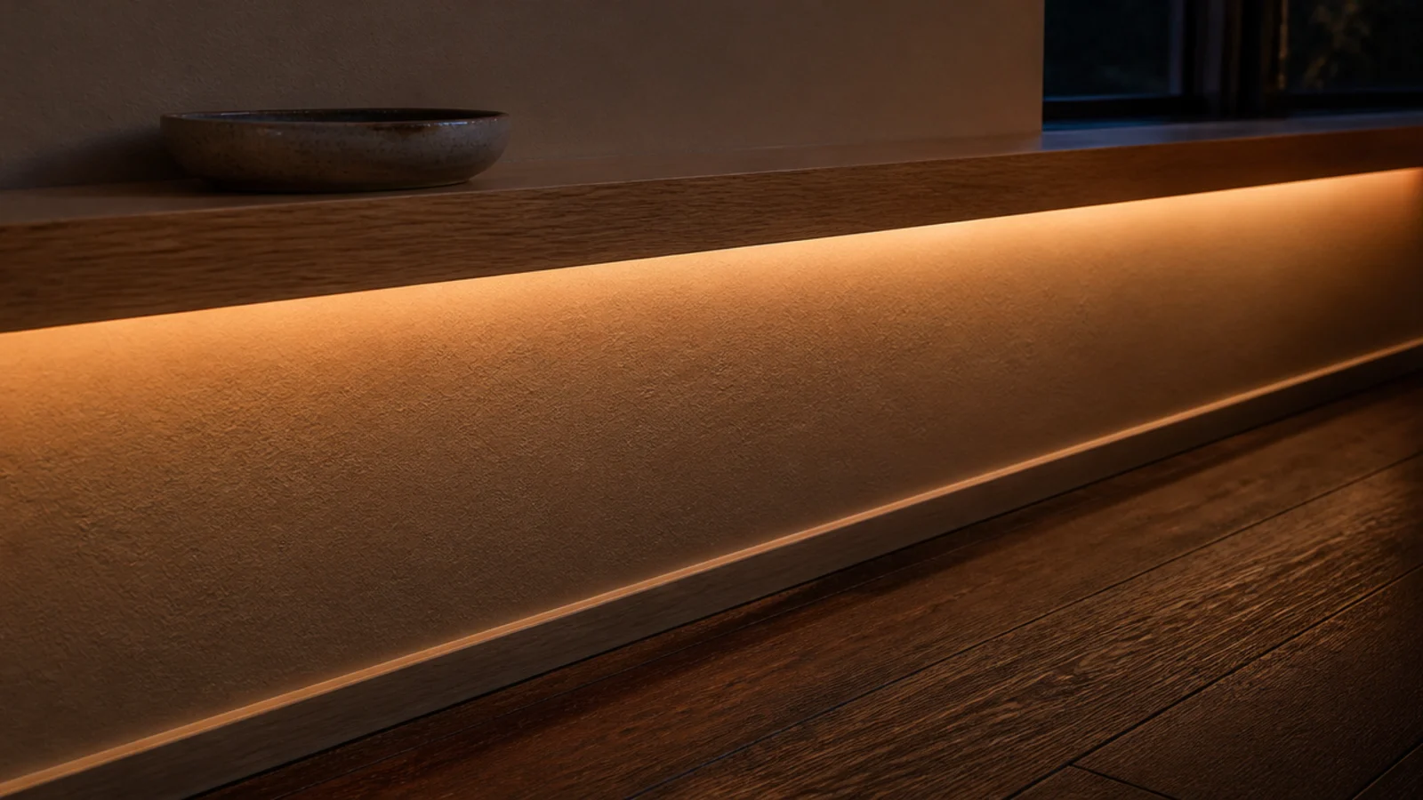 warm led strip glowing beneath a small entryway wall ledge at night