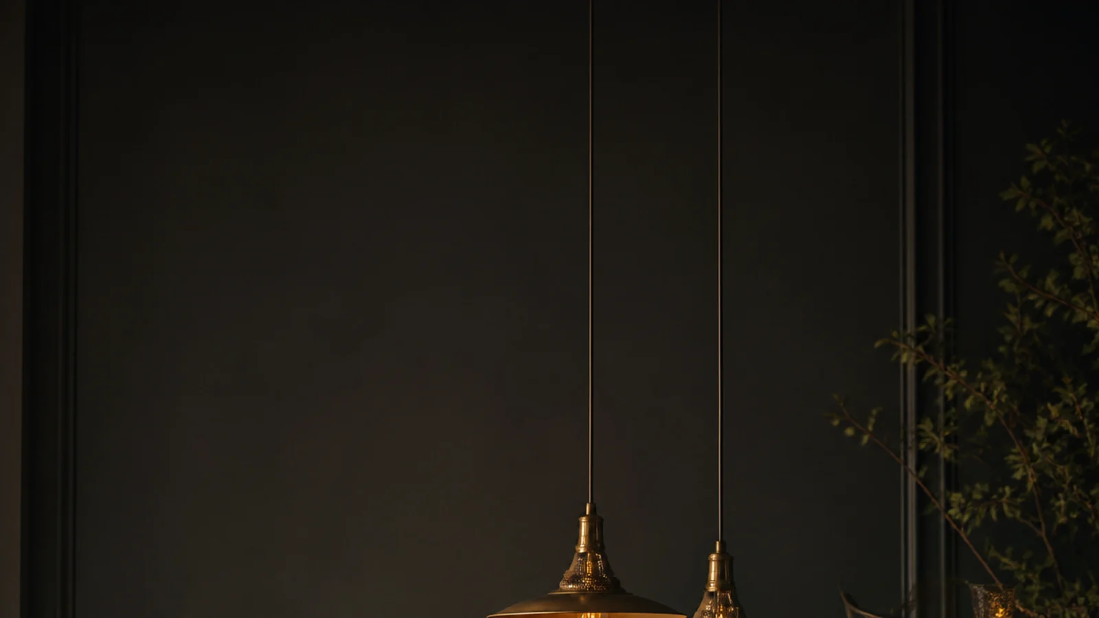 tall view of dining table hanging lights above a laid evening table