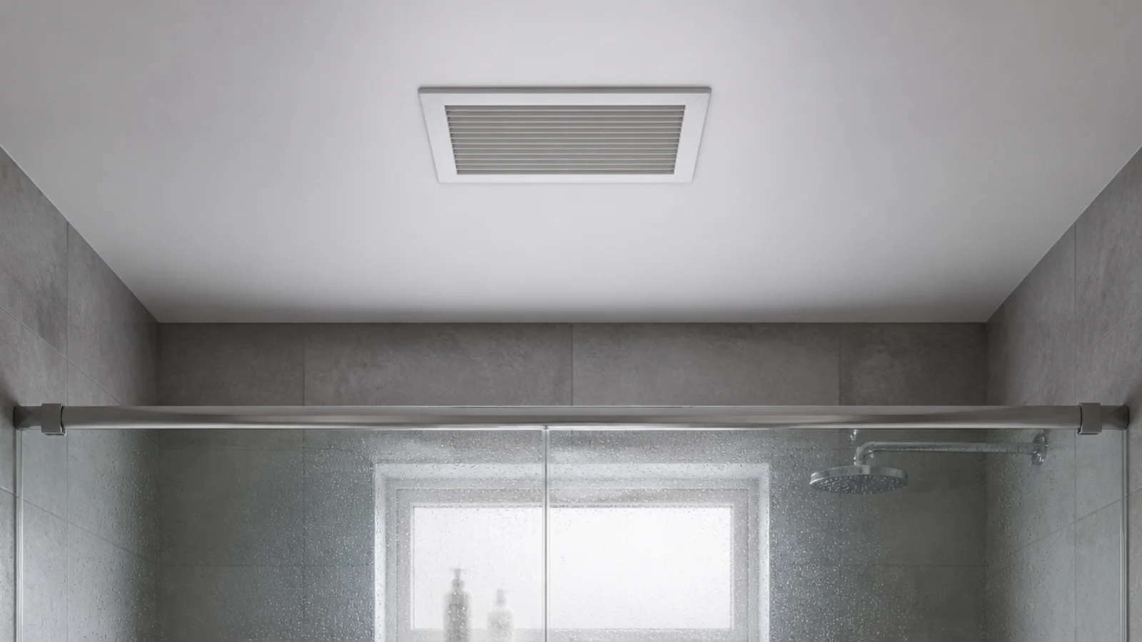 ceiling extractor fan grille above a tiled bathroom shower