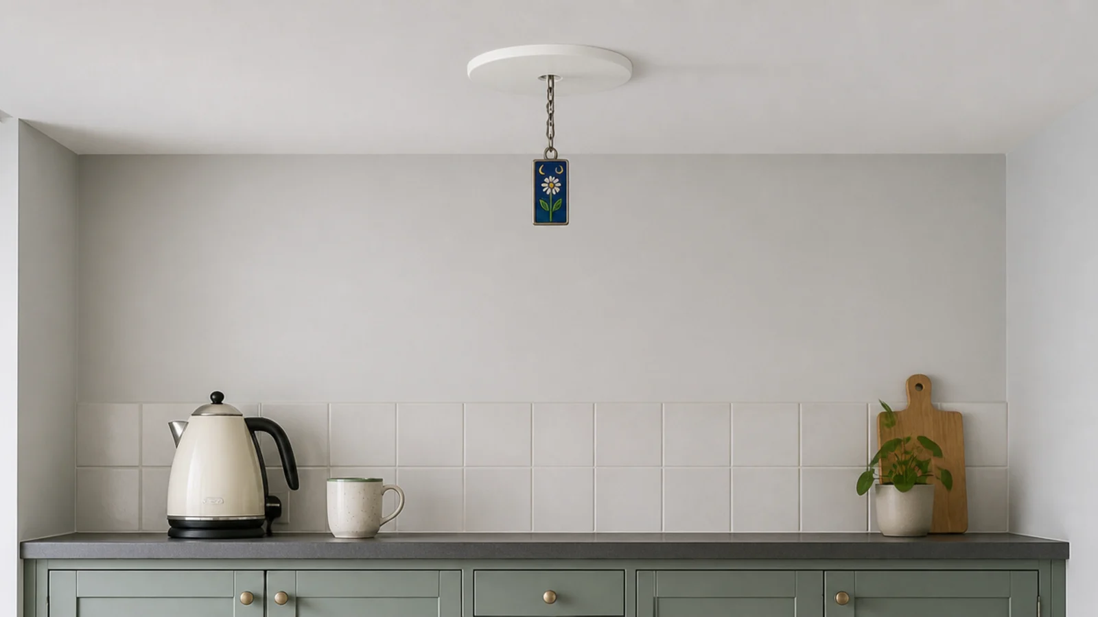 pendant hanging from a converted downlight in a rented kitchen