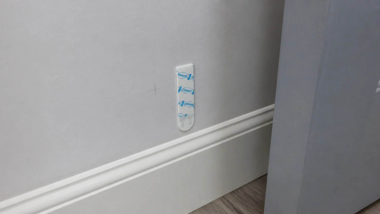 adhesive strip being tested on a hidden patch of rental paint