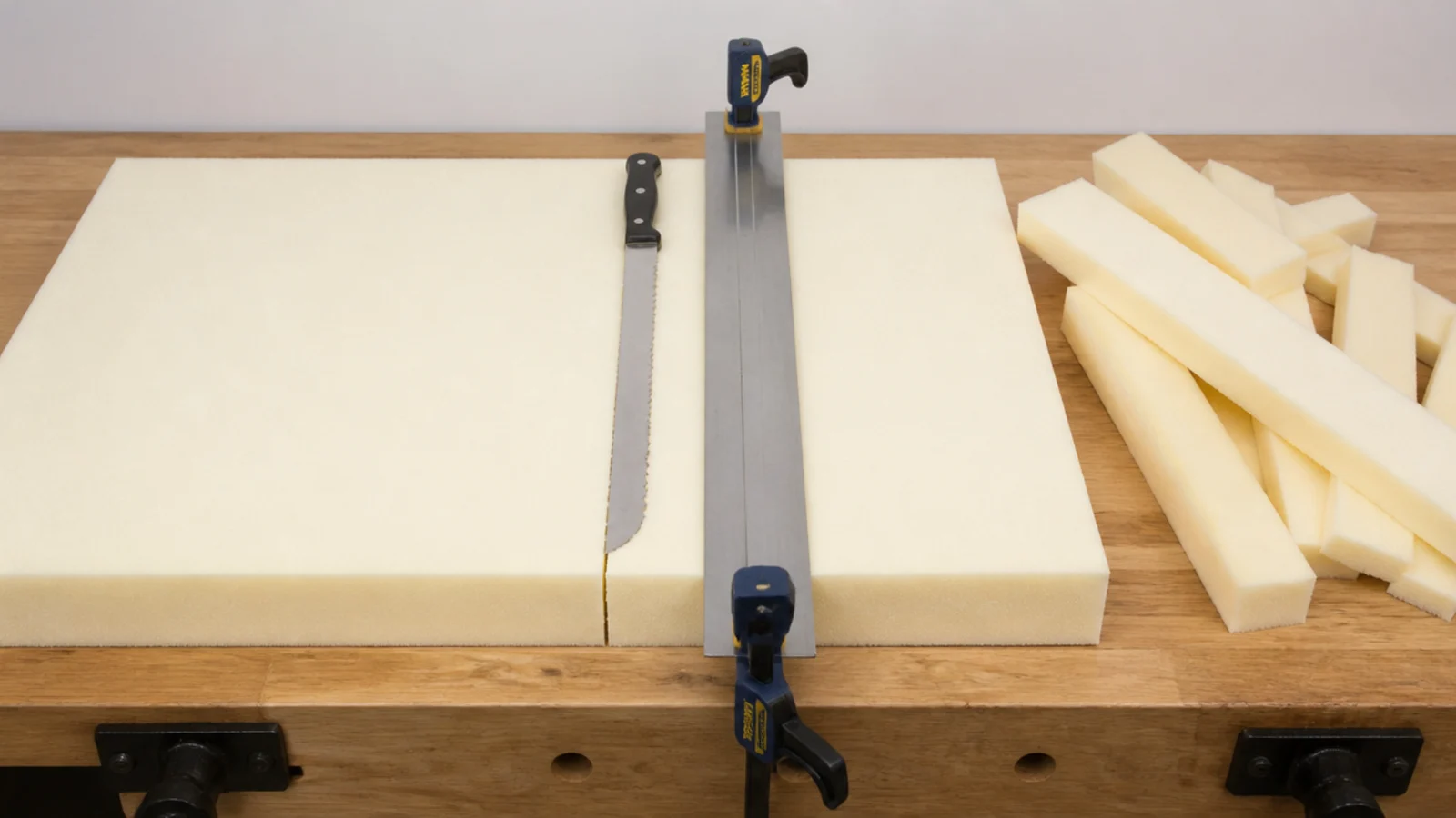 serrated knife slicing two inch upholstery foam for a diy headboard