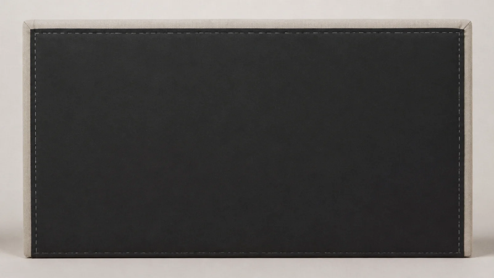 black cambric backing stapled across the rear of an upholstered headboard