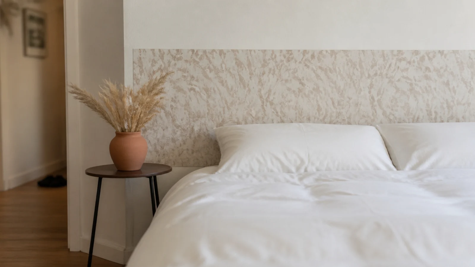 removable patterned wallpaper rectangle behind a bed in a rental bedroom