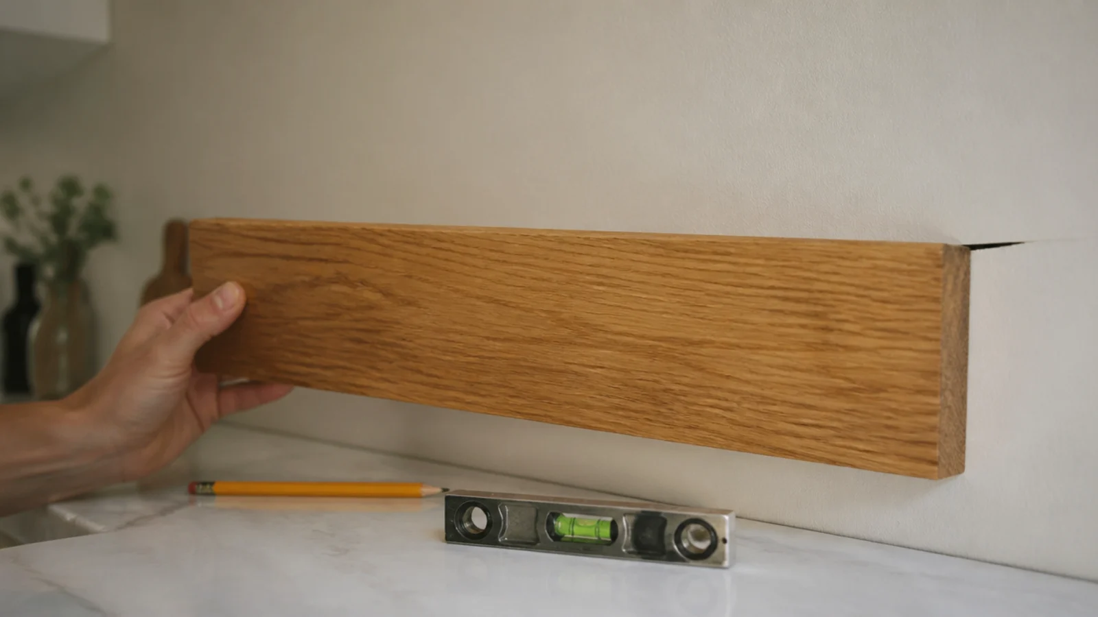 oak shelf board held against a kitchen wall showing a gap behind it