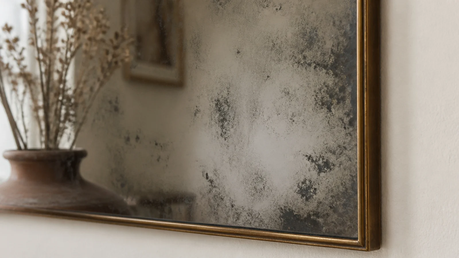 antiqued foxed mirror glass with soft mottling on a living room wall