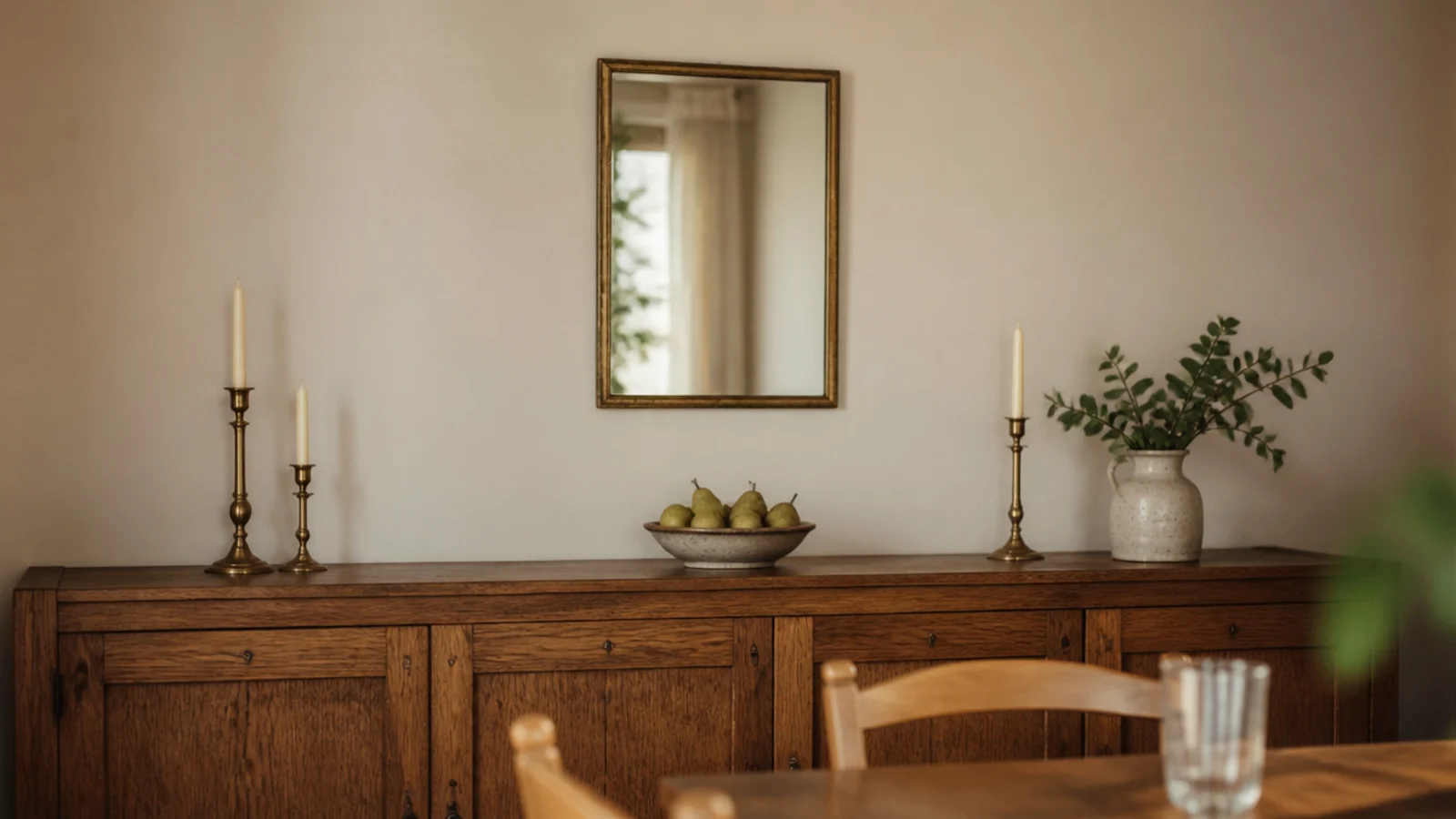 undersized mirror looking lost above a long dining room sideboard