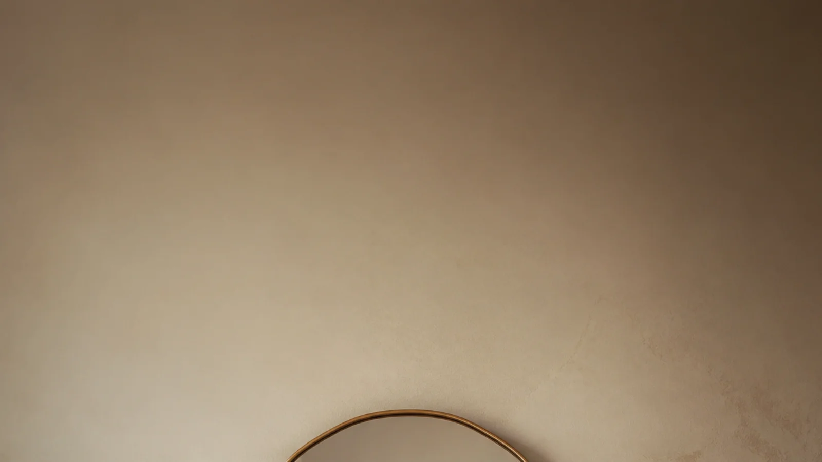 vertical image of corrected mirror wall decor above a styled oak console