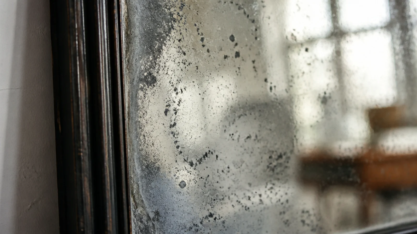 antique mercury glass mirror showing silvery mottling and dark speckles