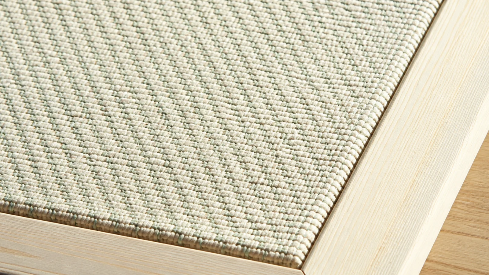 pale sea glass green pattern threaded through an otherwise ivory rug