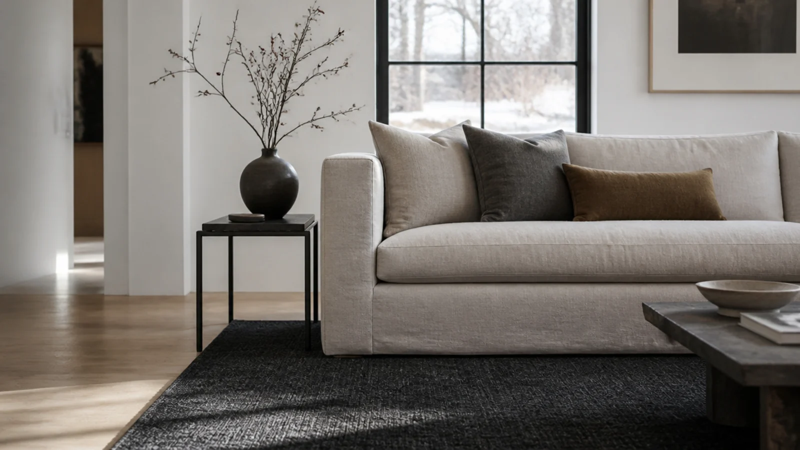 deep charcoal rug reading softer than a flat black would indoors