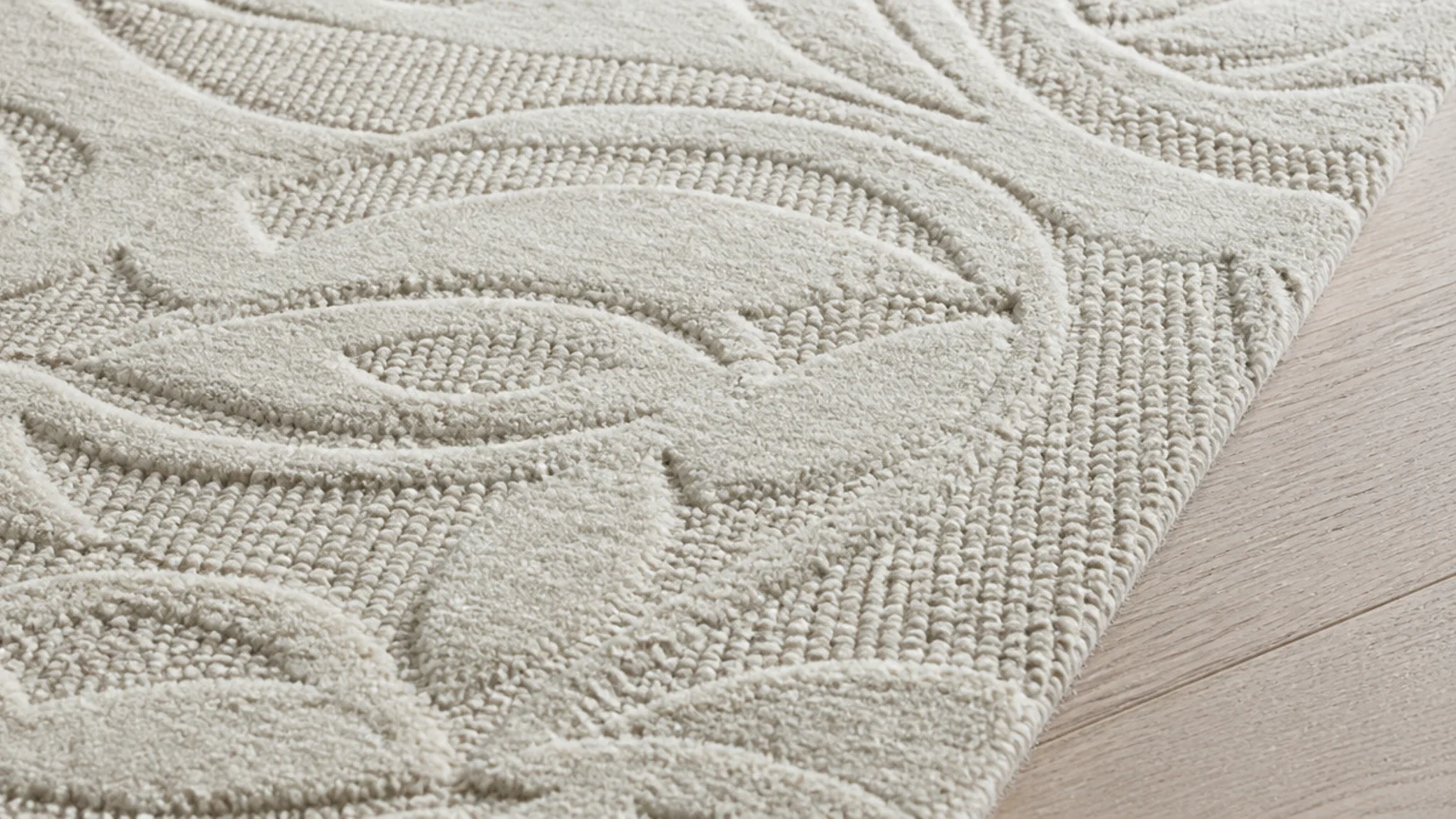 carved high low wool rug throwing soft shadows across its surface