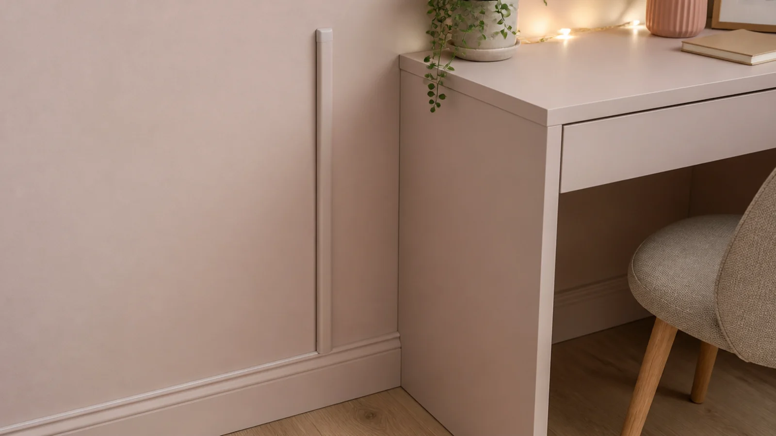 cable channel painted to match the wall behind a small desk