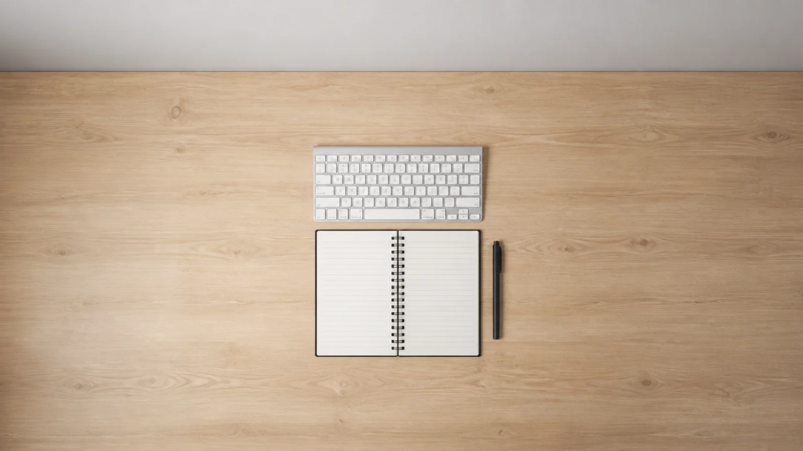wide timber desk top with generous empty space around the keyboard