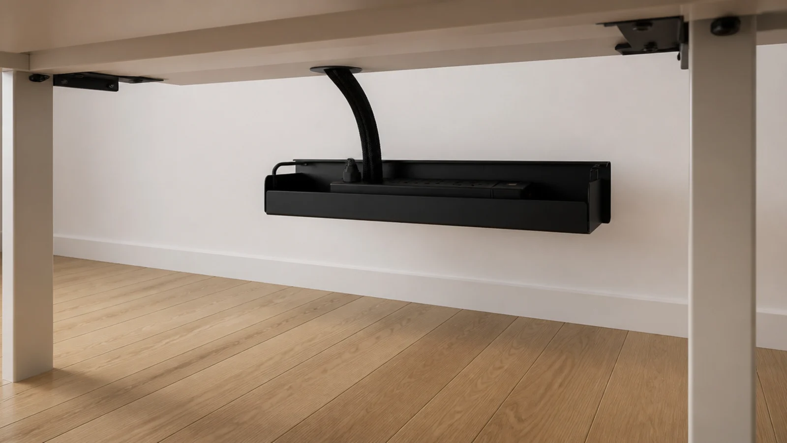 single cable run leaving a desk into one under mounted tray