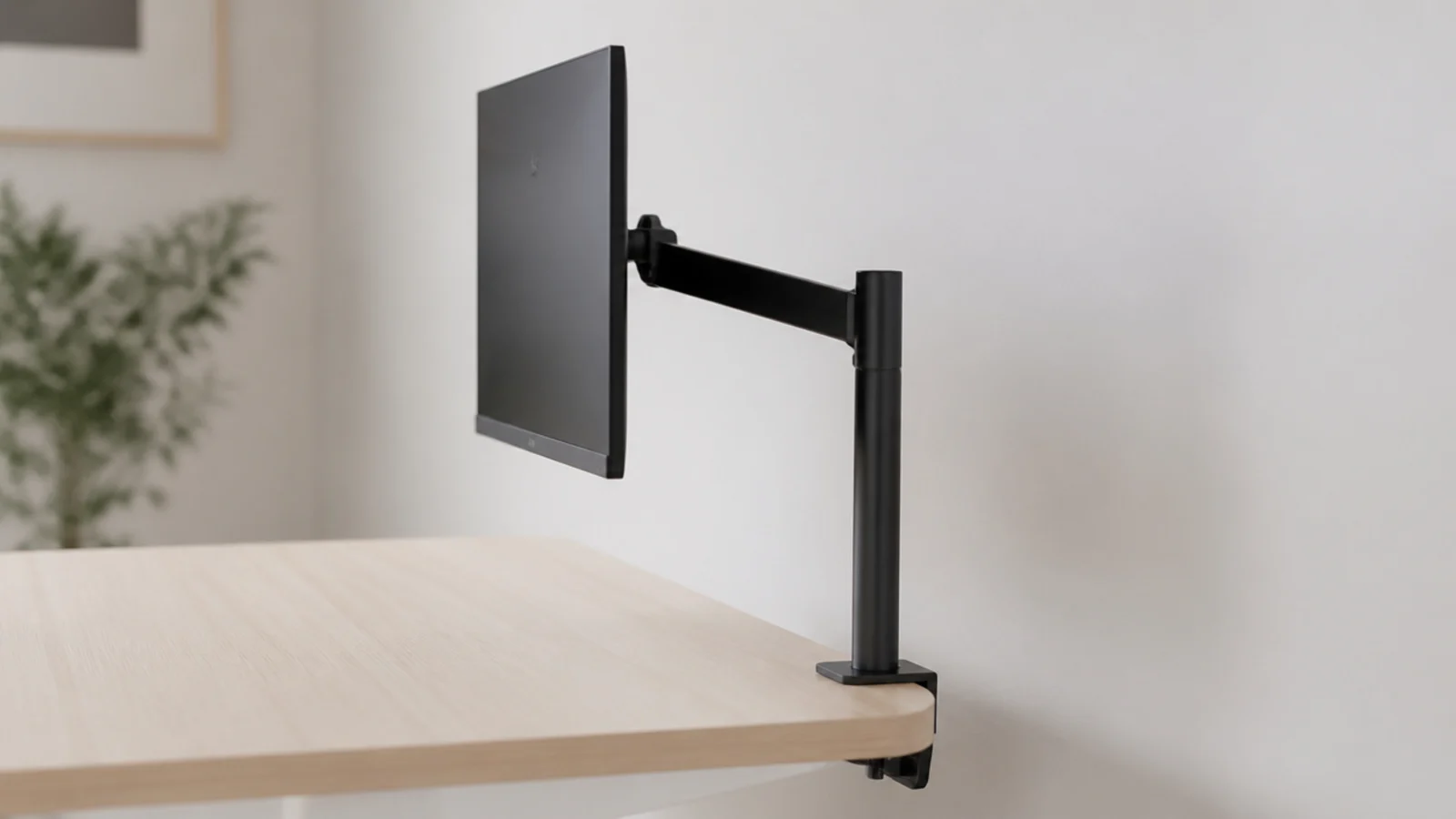 monitor suspended on a slim arm above a completely clear desk