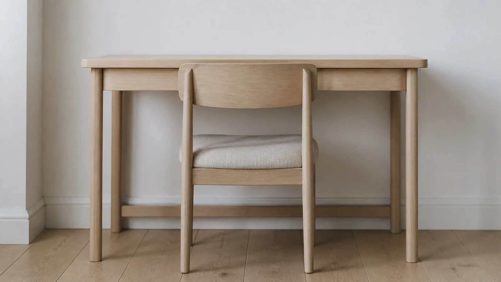 plain low back timber chair pushed under a minimalist desk