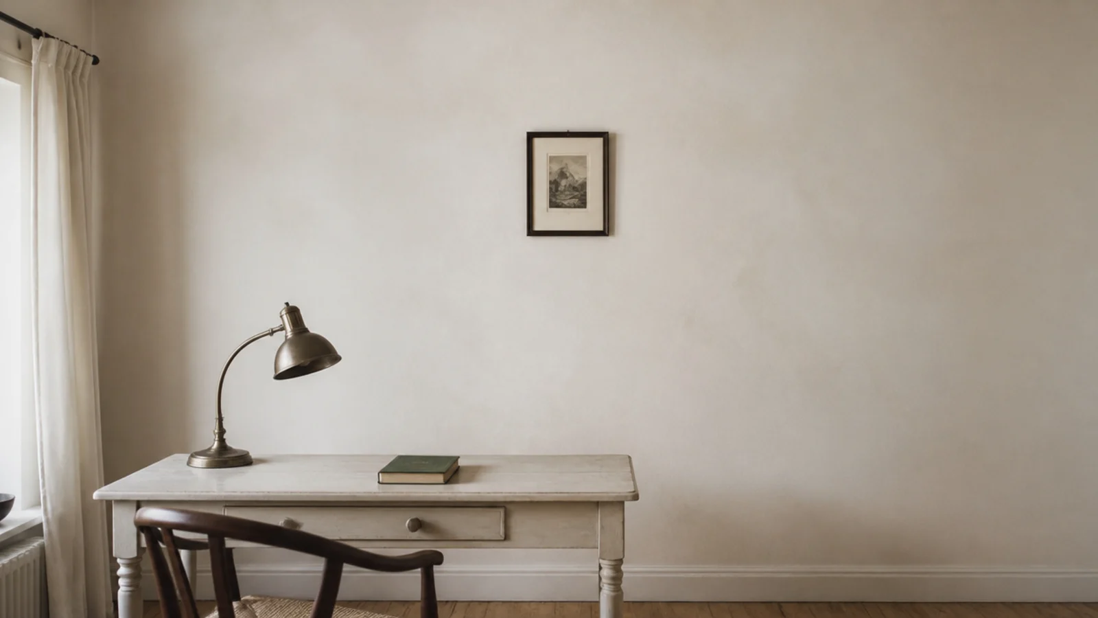 one small framed print alone on a wide bare study wall