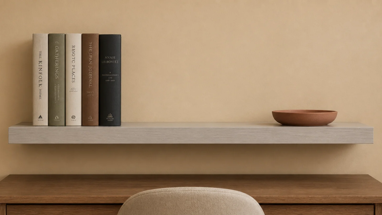 shelf styled with upright books at one end and a flat dish