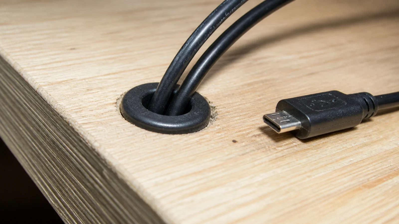 small grommet ring with cables jammed tightly through the opening