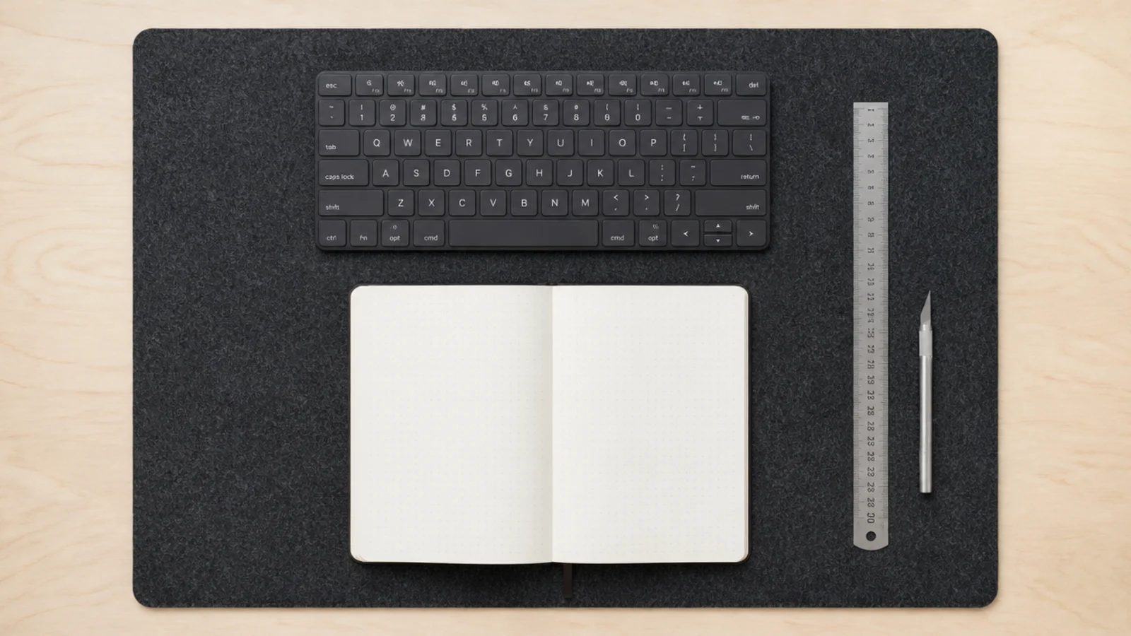 charcoal felt pad cut to size sitting on a plywood desk top