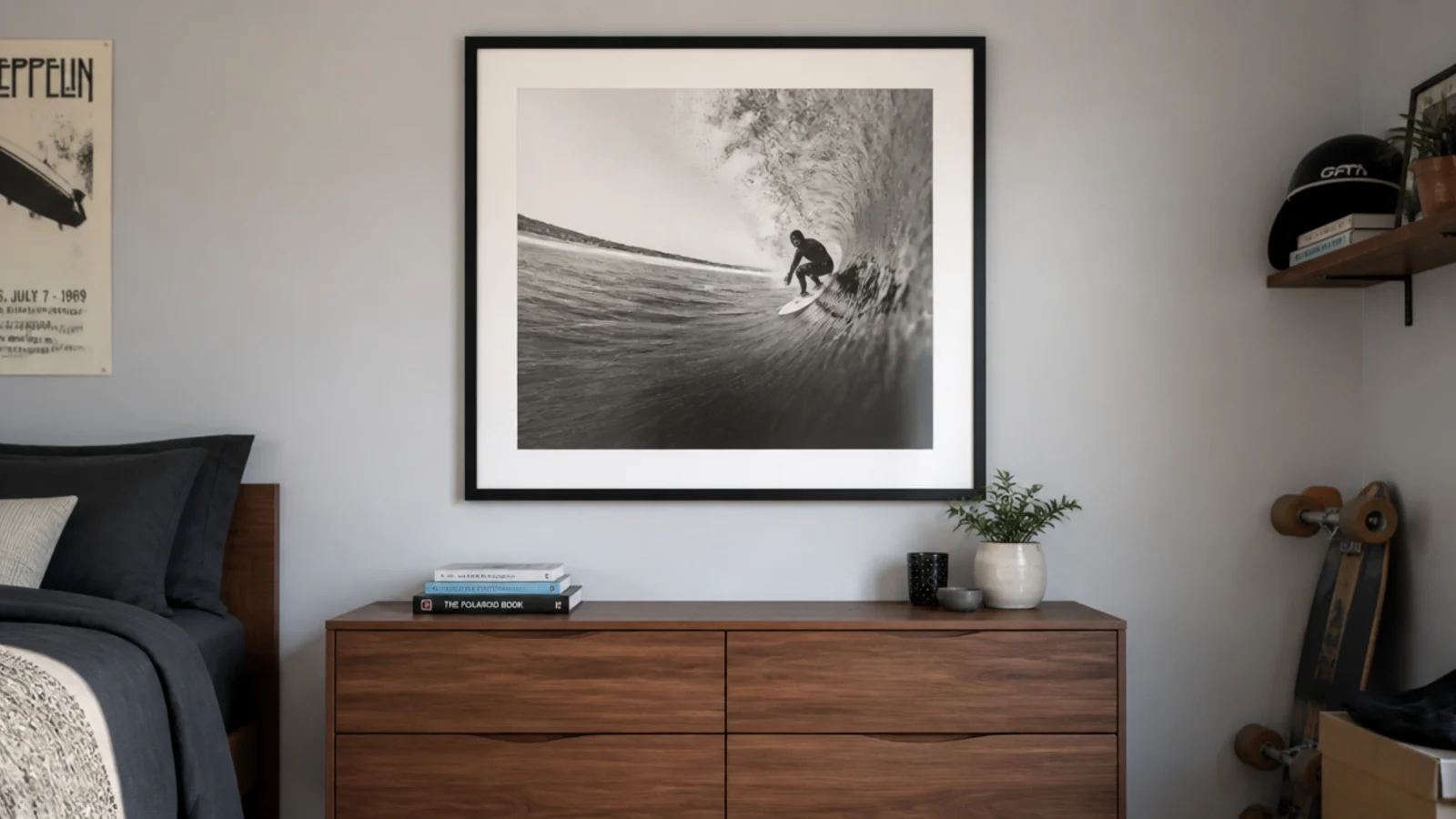 large black framed print hung centrally above a low chest of drawers