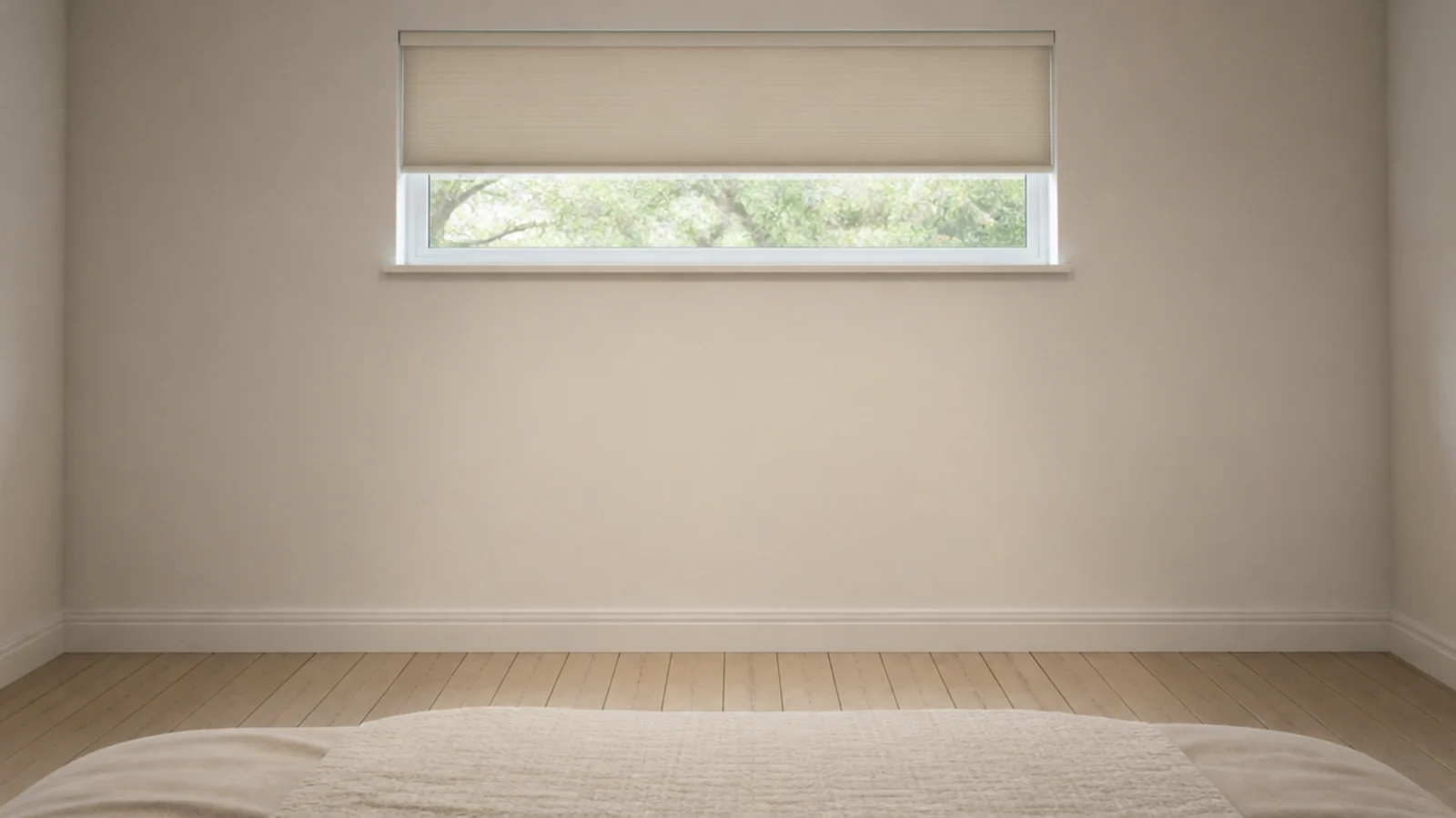 empty wall beneath a bedroom window with no furniture against it