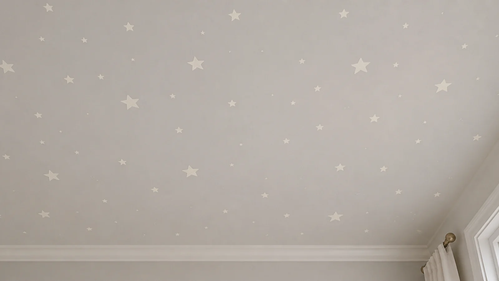 small painted stars scattered across a pale bedroom ceiling
