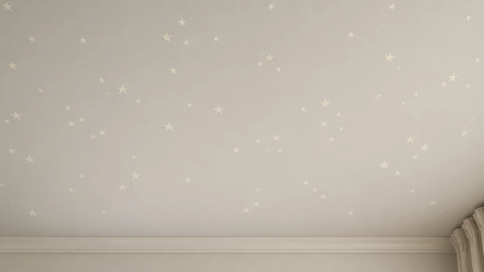 hand painted cream stars scattered across a pale bedroom ceiling