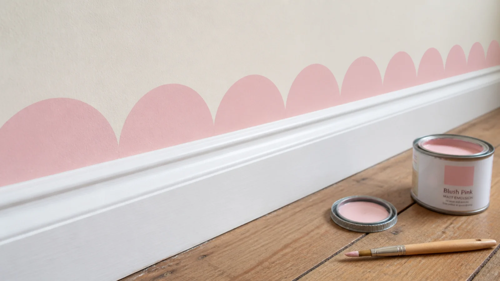 row of painted scallops running along a wall above white skirting