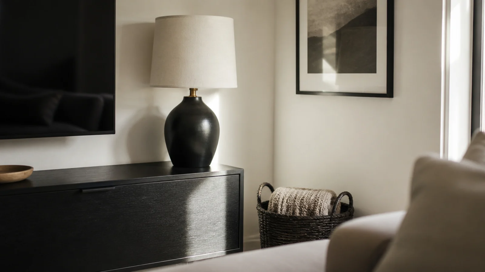 dark basket lamp base and frame echoing the black of a television