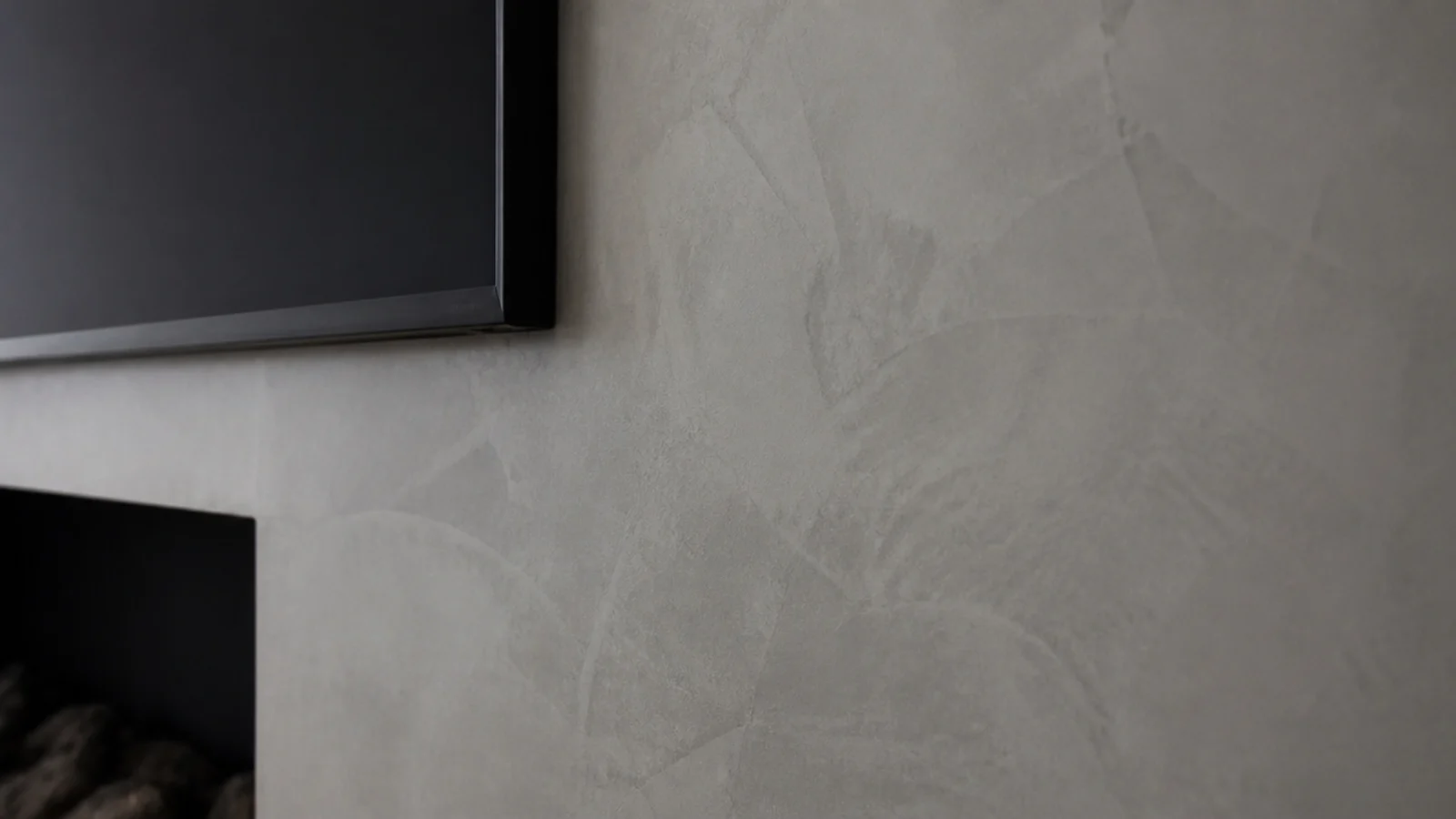 hand troweled micro cement finish across a modern media wall surface