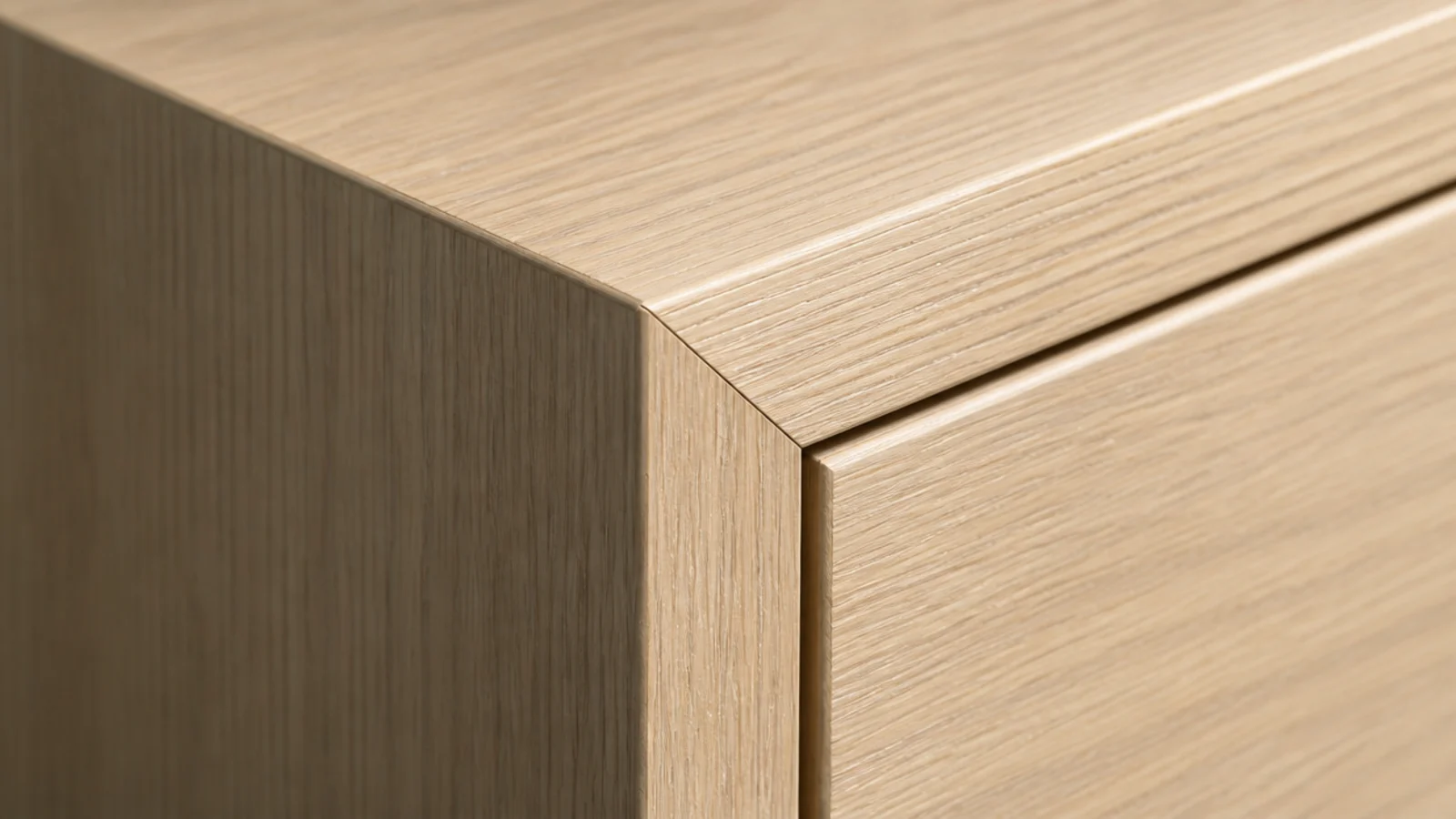 crisp mitred corner joint on a modern media cabinet in pale veneer