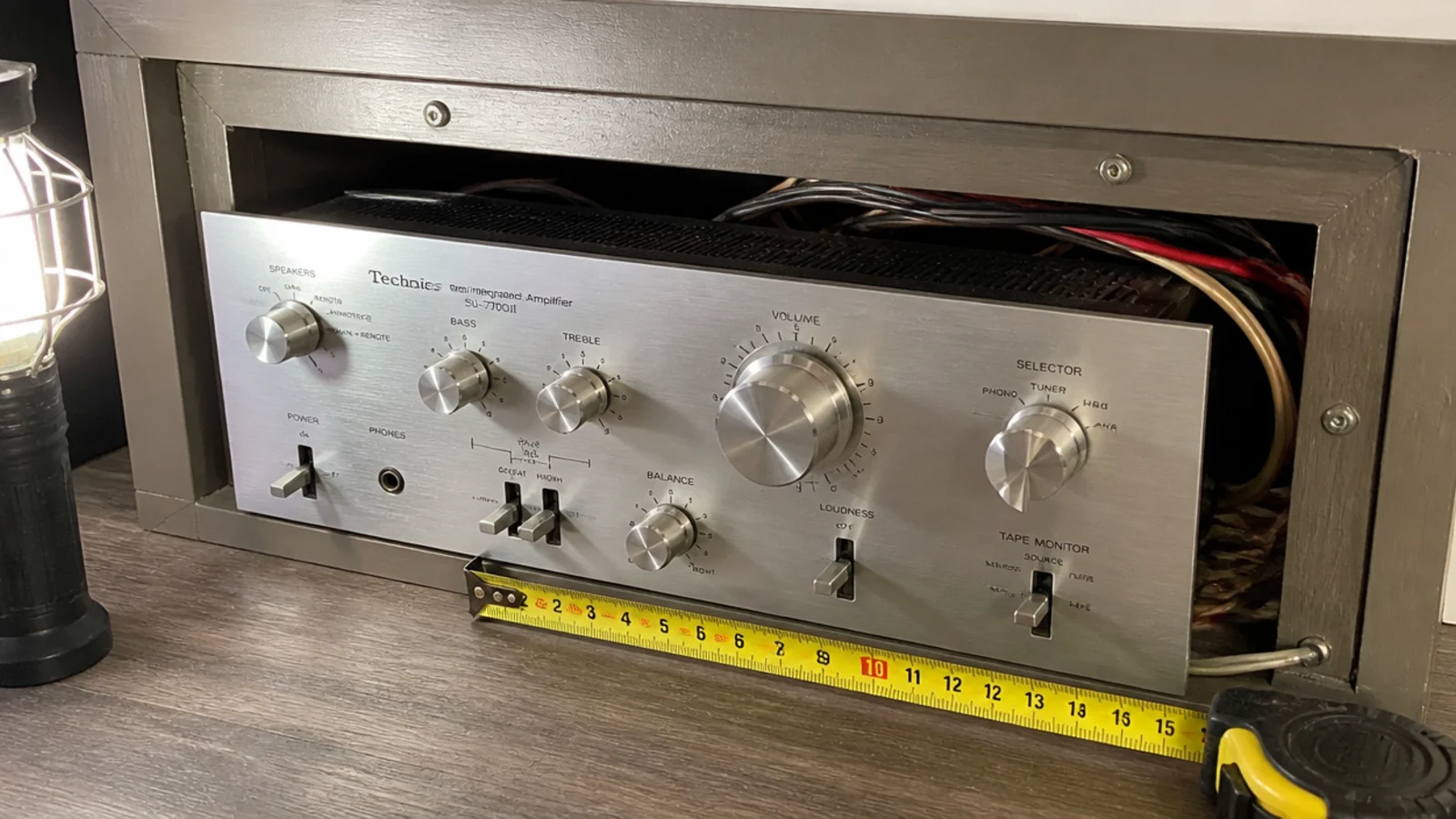 amplifier sitting proud of a cabinet that is too shallow for it