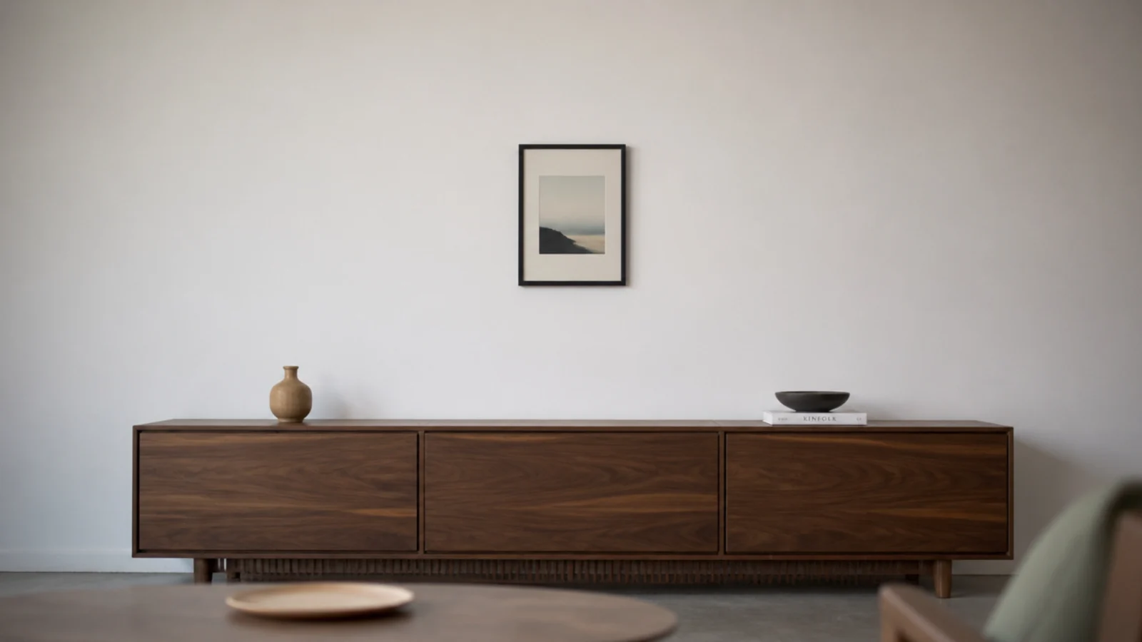 small framed print stranded on a wide wall above a media unit