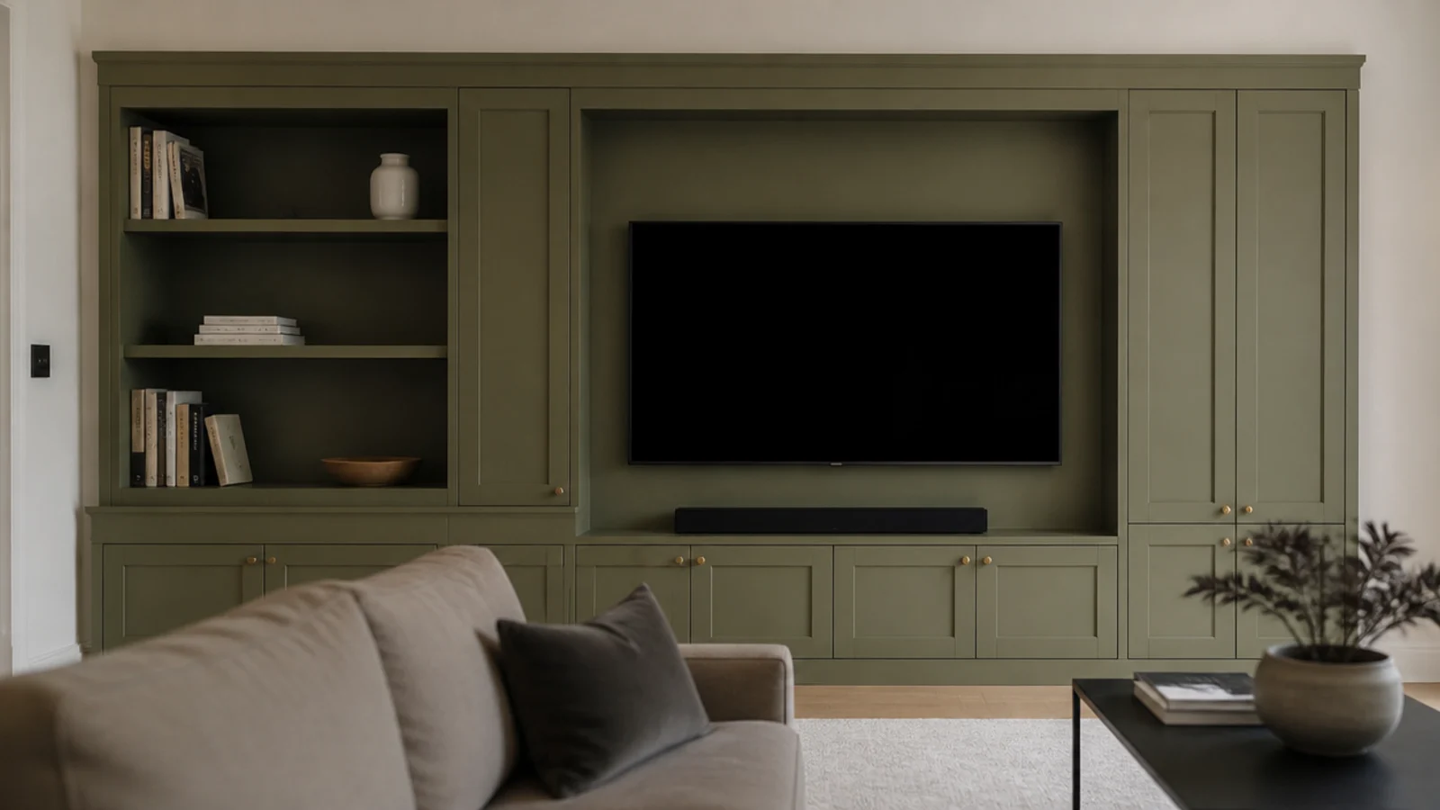 media wall with deliberately unequal bay widths flanking a screen