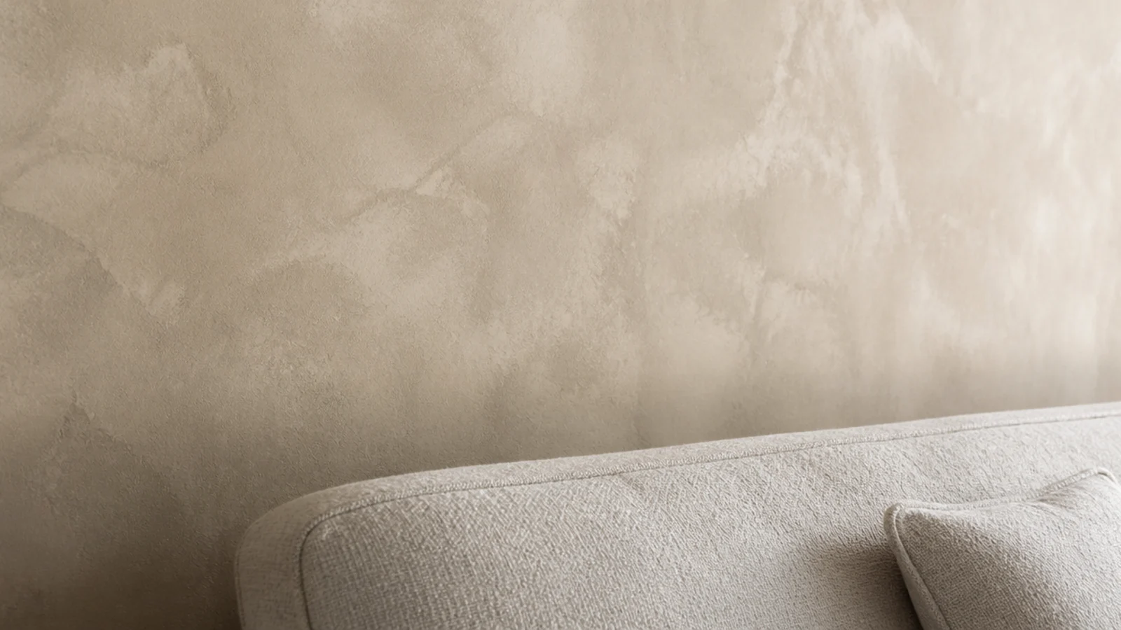 limewashed wall behind a sofa with a sealed matt surface