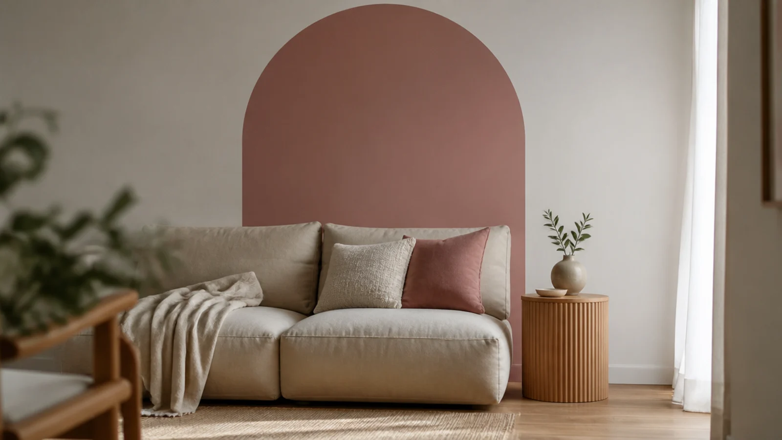 painted arch shape rising above a sofa on a two tone wall