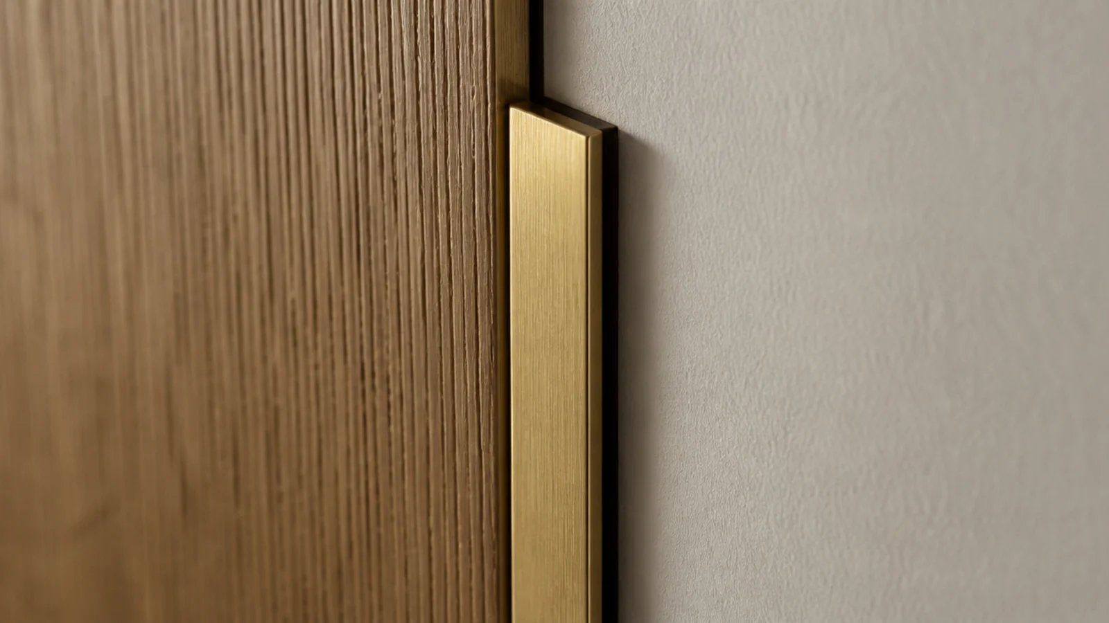 slim brass trim forming a shadow gap around a wall panel edge