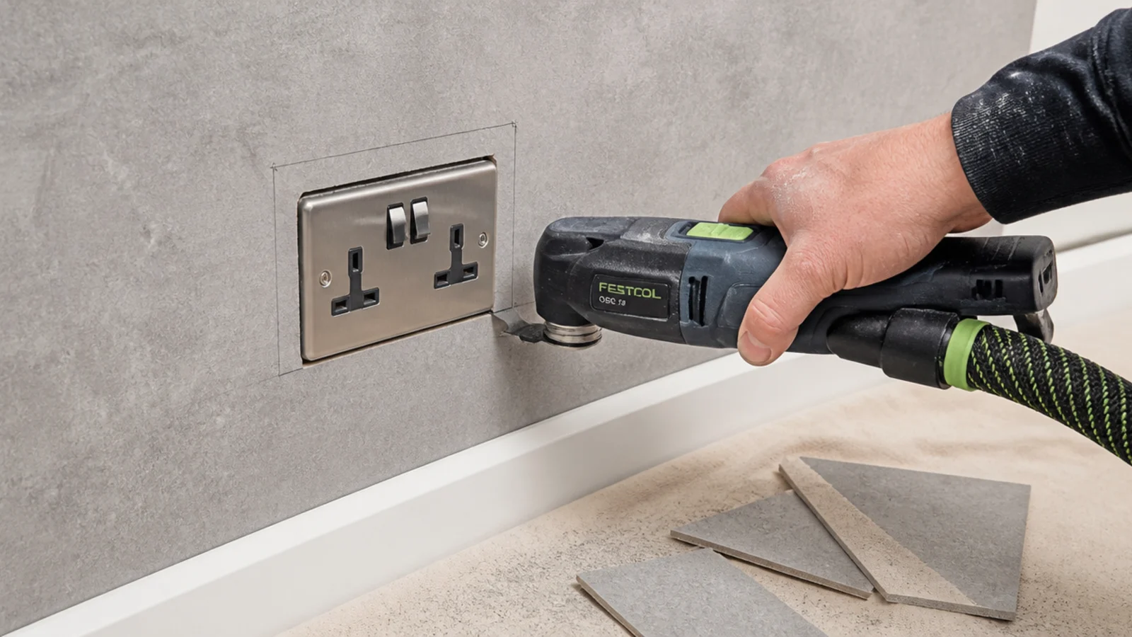 panel being trimmed to fit neatly around an existing wall socket