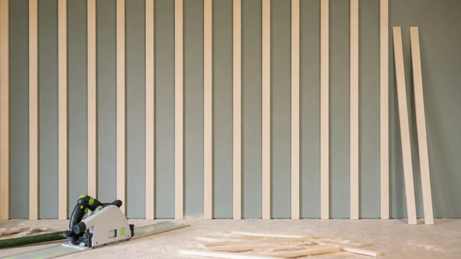 evenly ripped whitewood battens fixed vertically across a painted wall