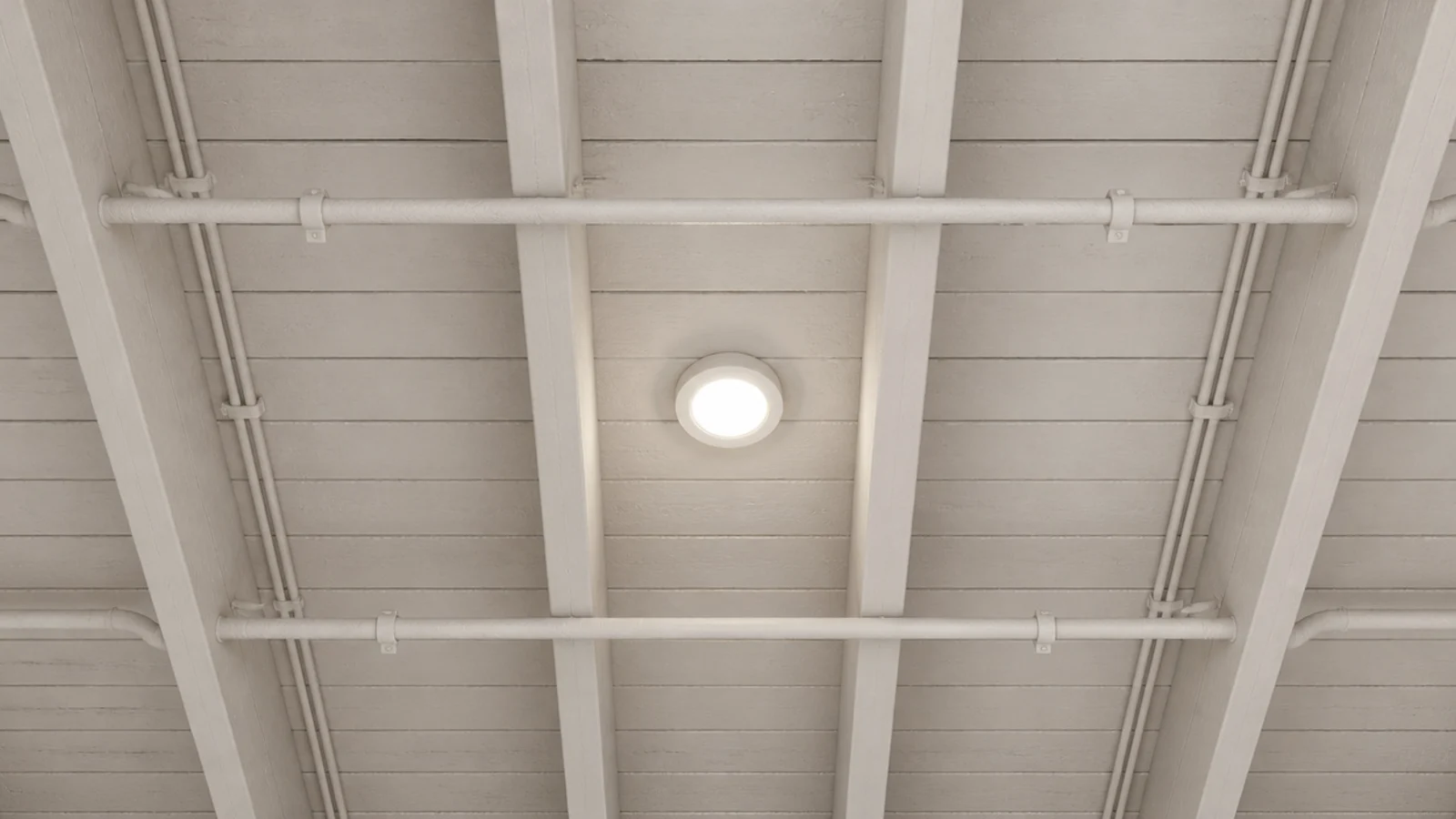 exposed cellar joists pipes and cables all sprayed the same pale tone