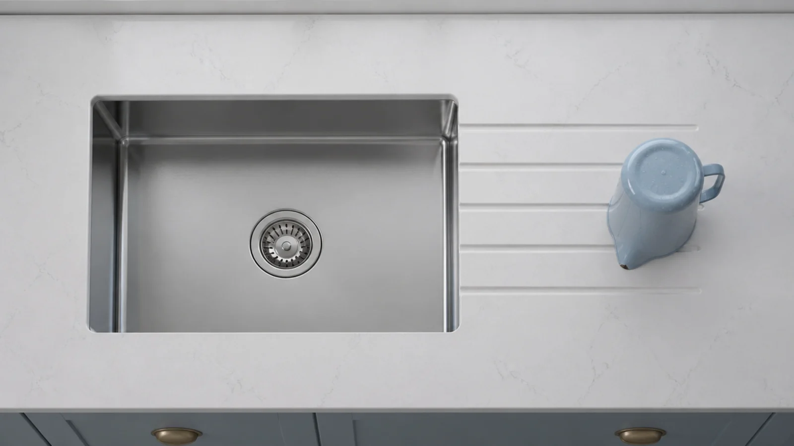 undermount stainless sink with drainer grooves routed into the worktop