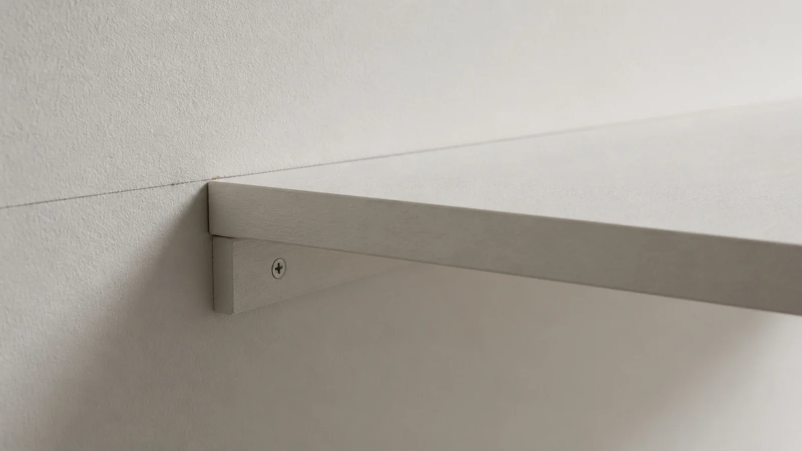 timber batten screwed along a wall carrying a shelf board without brackets