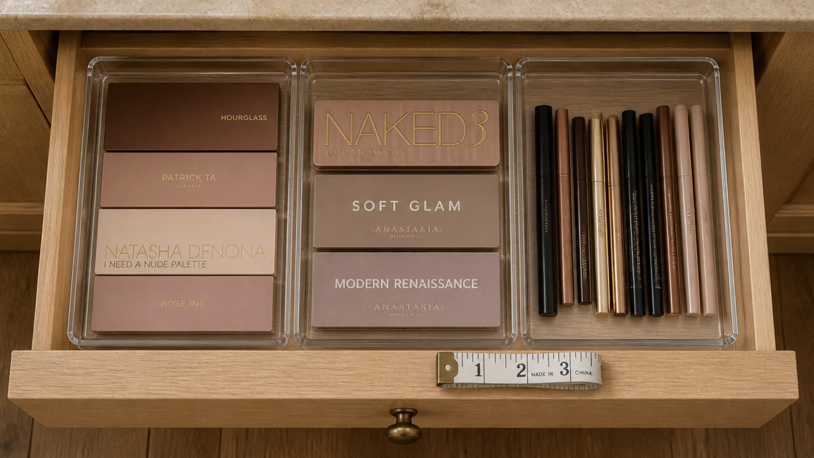 clear drawer inserts fitted into a vanity drawer holding palettes upright