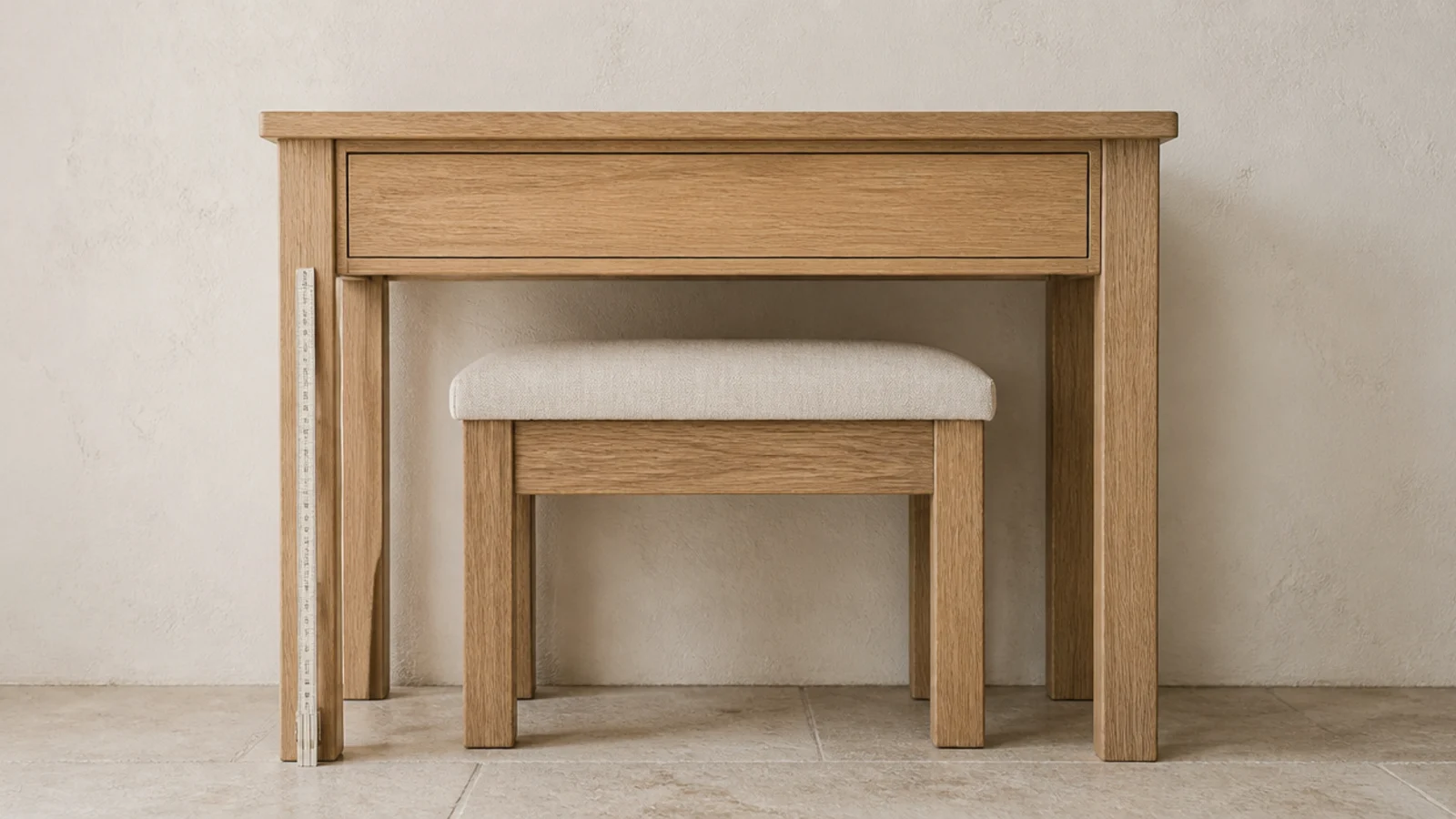 empty oak dressing table measured for height with a stool tucked beneath