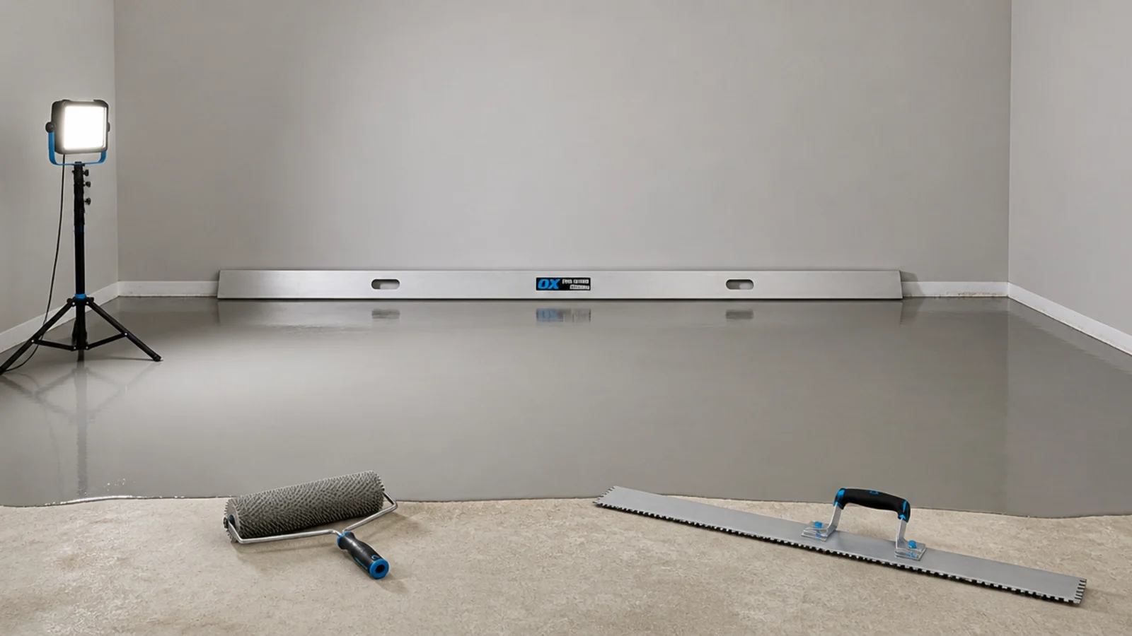 self levelling compound poured and spread across a bare parquet subfloor